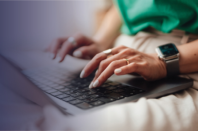 Woman on phone with a laptop